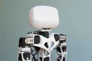 A white humanoid robot with a smooth, rounded head