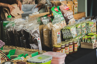 A stall of packaged African food products, including cassava chips and spices