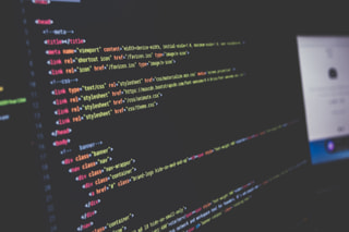 Close-up of website code in a text editor on a dark screen