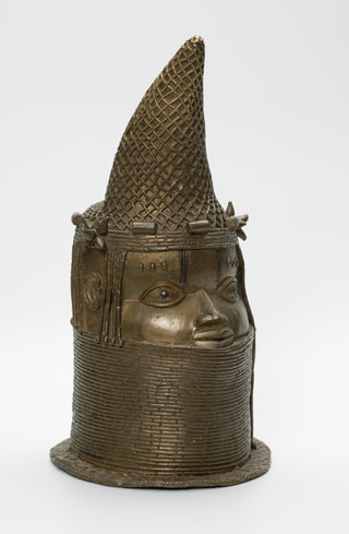 Cast brass head of an Iyoba, a Benin queen mother, wearing a tall beaded crown